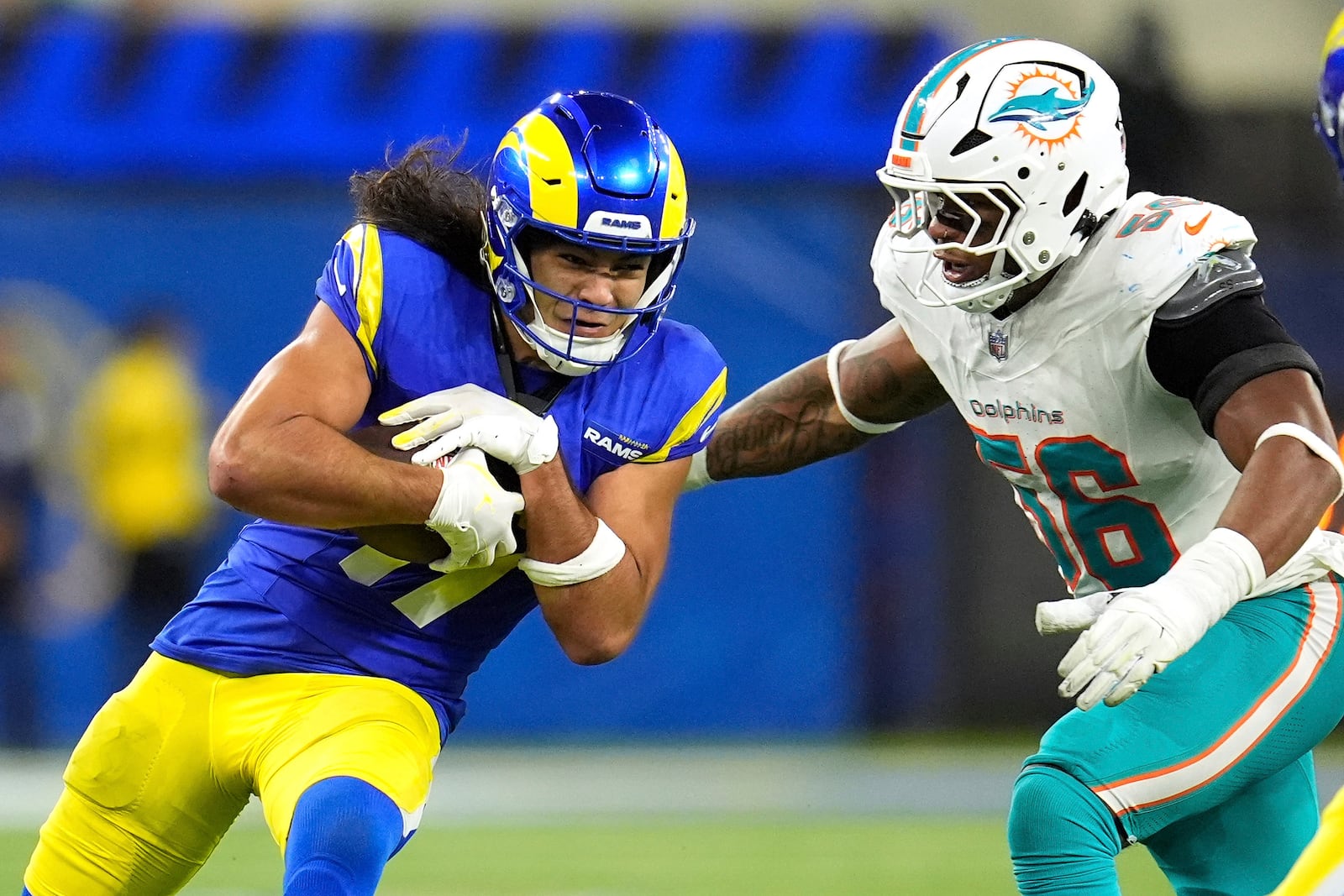 Los Angeles Rams wide receiver Puka Nacua, left, is tackled by Miami Dolphins linebacker Quinton Bell during the second half of an NFL football game, Monday, Nov. 11, 2024, in Inglewood, Calif. (AP Photo/Marcio Jose Sanchez)