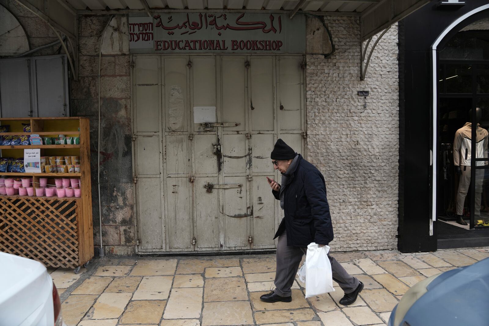 The shuttered Educational Bookshop, is seen after Israeli police raided the long-established Palestinian-owned bookstore in east Jerusalem, detaining its owners and confiscating books about the decades-long conflict saying the books incited violence, Monday, Feb. 10, 2025. (AP Photo/Mahmoud Illean)