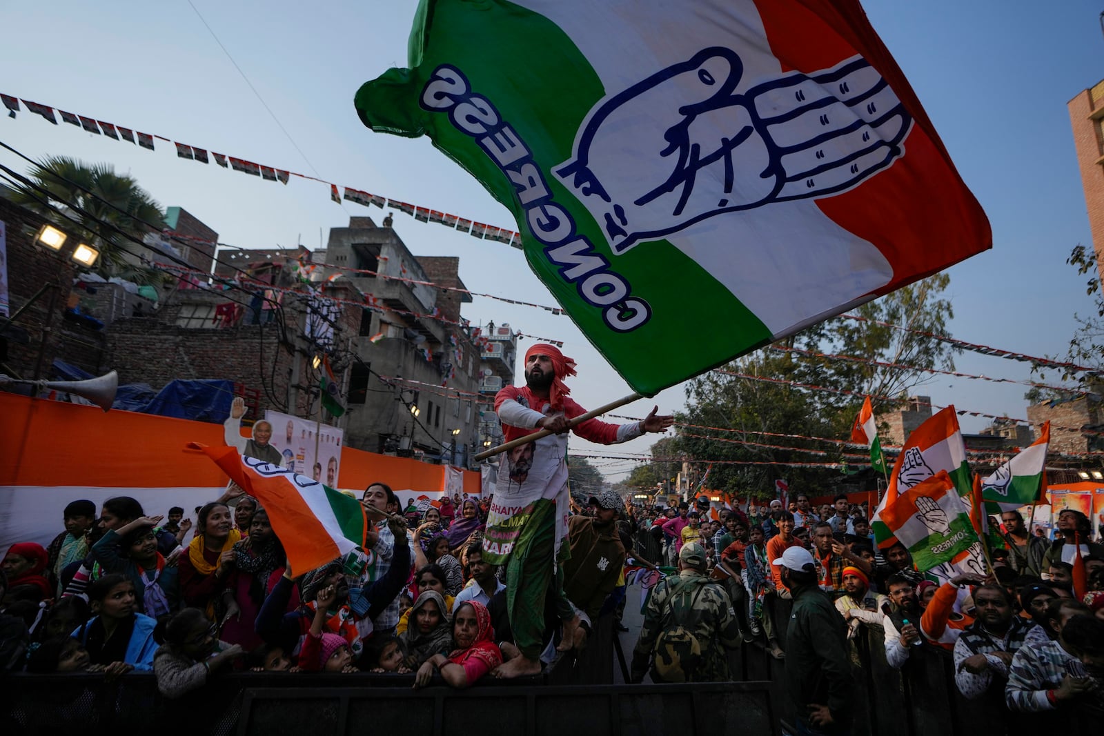 Supporters of Congress party wave their party's flag during Delhi Assembly elections campaign rally in Delhi, India, Thursday, Jan. 30, 2025. (AP Photo/Channi Anand)