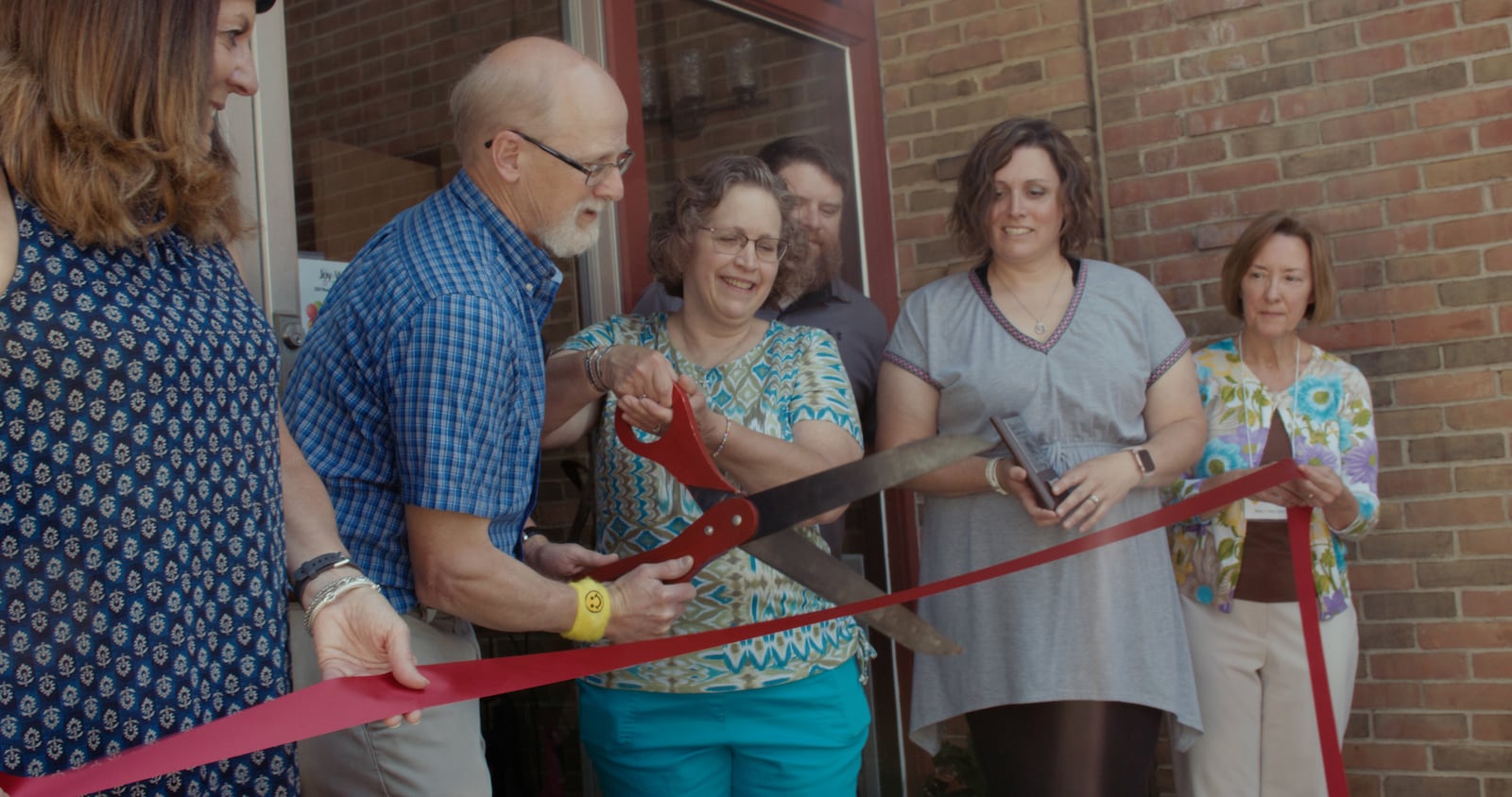 David and Jane (holding scissors) cut the ribbon at the grand opening of Joy & Whimsy Depot in Lewisburg. CONTRIBUTED