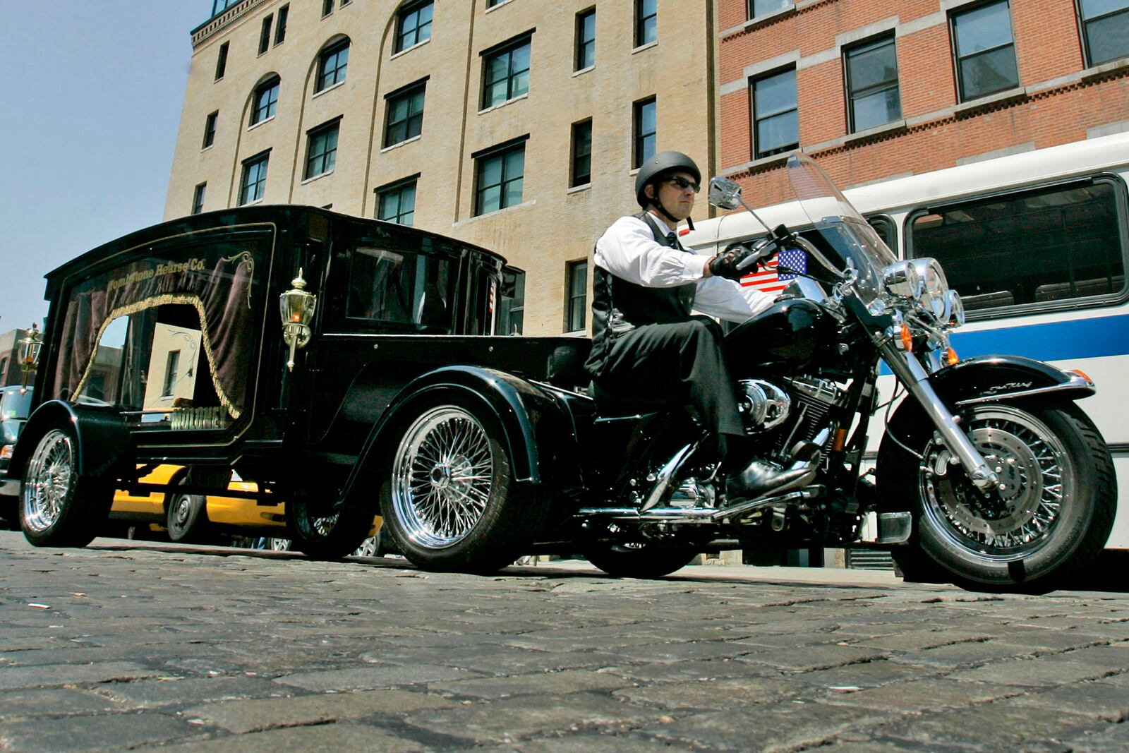 FILE — Peter Moloney, of Moloney Family Funeral Homes in Lake Ronkonkoma, N.Y., rides his Harley Davidson hearse from the Tombstone Hearse Co. of Alum Bank, Pa., in New York, May 24, 2007. (AP Photo/Richard Drew, File)