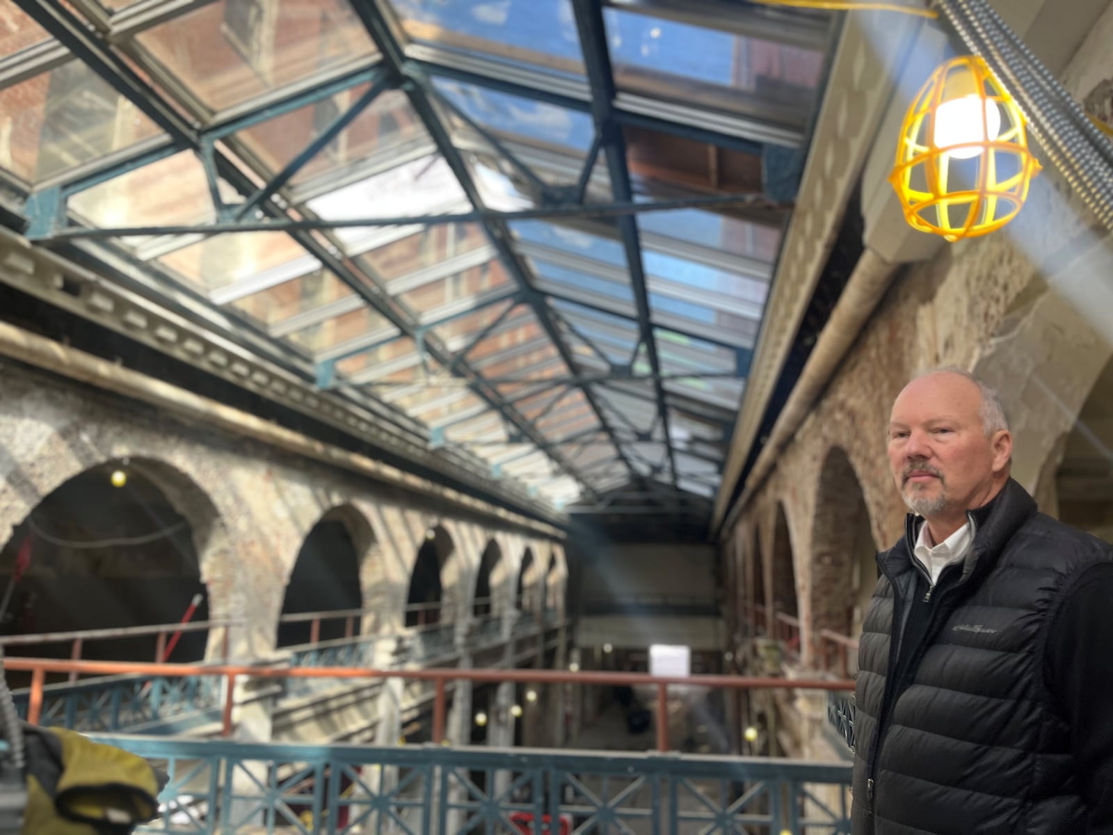 Dave Williams, senior development director with Cross Street Partners, stands in the Third Street arcade building in the Dayton Arcade. The building is being turned into a retail hub and a new hotel.  Cross Street is one of the main developers of the arcade complex. CORNELIUS FROLIK / STAFF