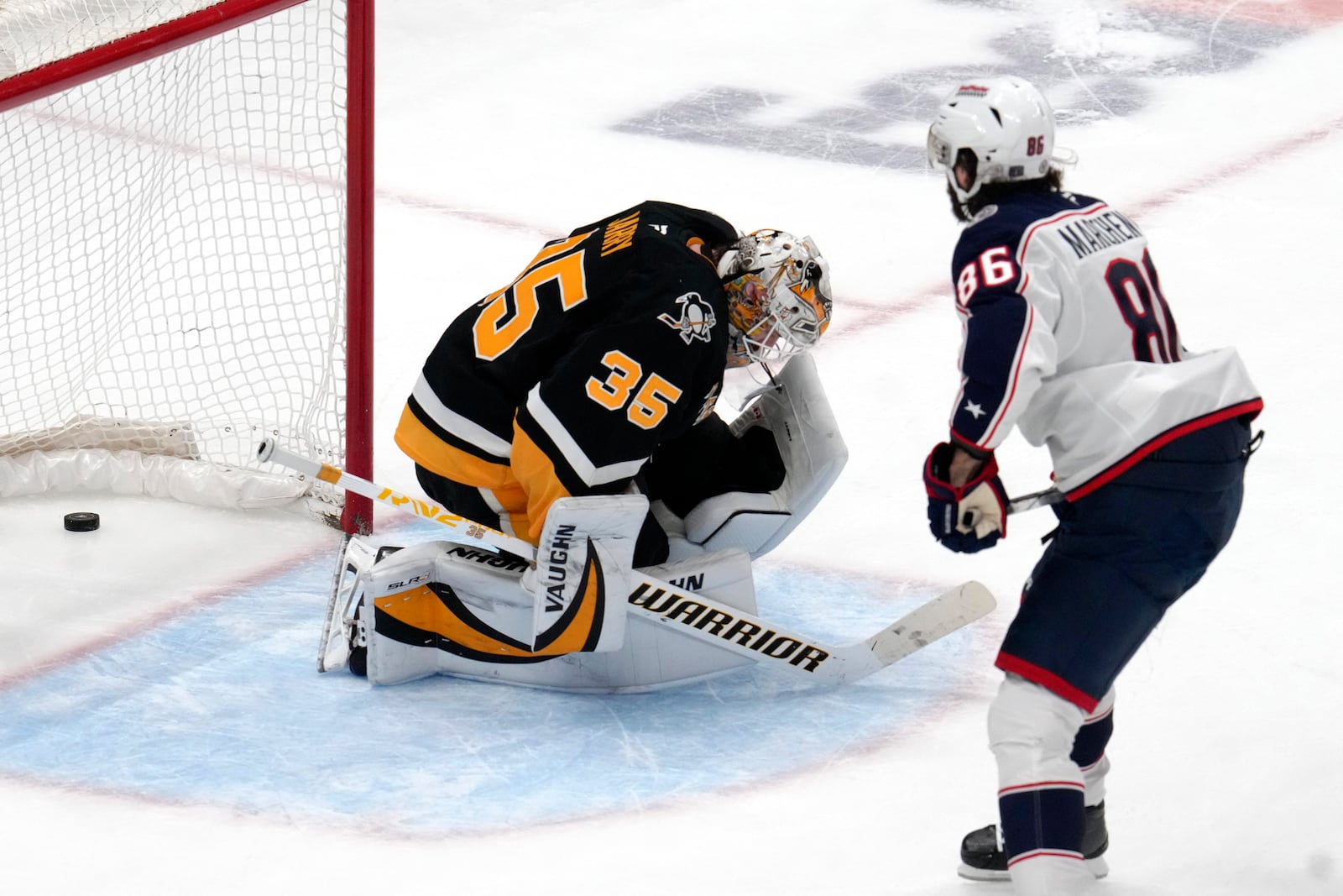 Columbus Blue Jackets' Kirill Marchenko (86) gets his game-winning shootout goal behind Pittsburgh Penguins goaltender Tristan Jarry (35) during an NHL hockey game in Pittsburgh, Tuesday, Jan. 7, 2025. (AP Photo/Gene J. Puskar)