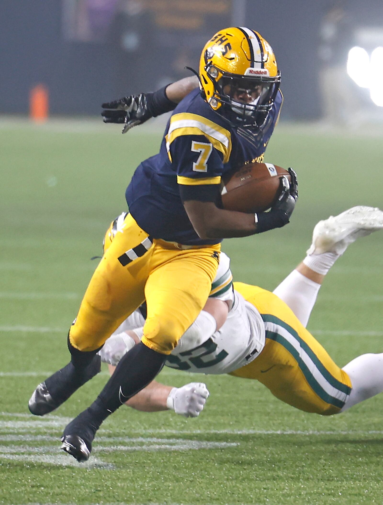 Springfield's Jayvin Norman avoids a tackle as he carries the ball against Lakewood St. Edward on Friday, Dec. 1, 2023. St. Edward pulled away late for a 31-21 win, their third straight title win against Springfield. BILL LACKEY/STAFF