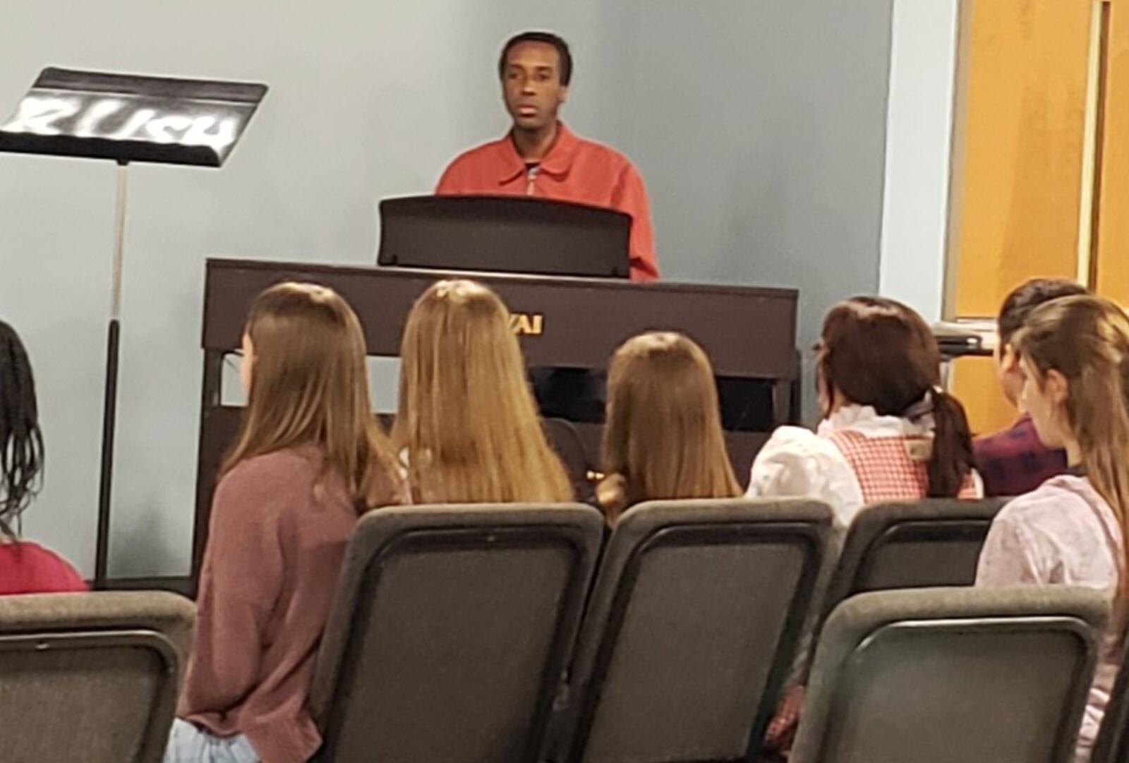 Class Act Drama's music director Nathan Price warms up with the students. JESSICA GRAUE/STAFF