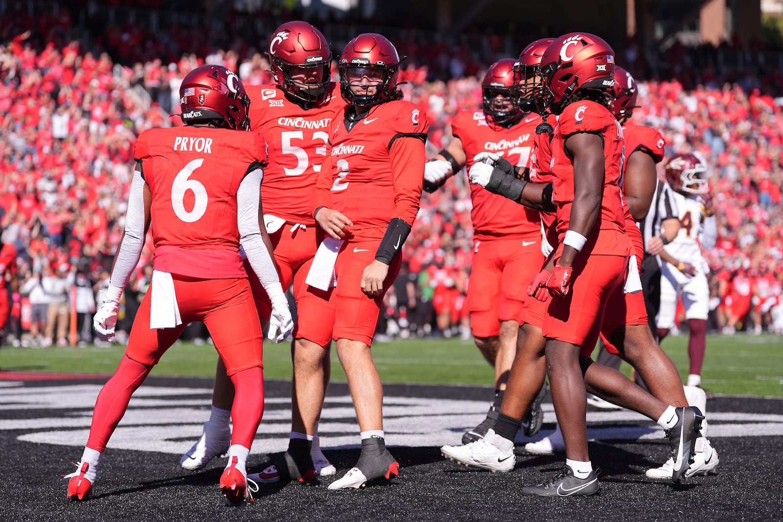 Cincinnati's Brendan Sorsby, center, celebrates a touchdown run during the first half of an NCAA college football game against Arizona State, Saturday, Oct. 19, 2024, in Cincinnati. (AP Photo/Kareem Elgazzar)