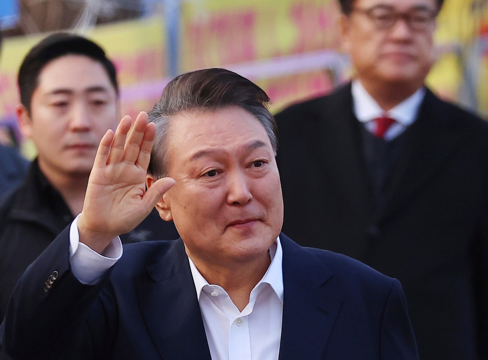 Impeached South Korean President Yoon Suk Yeol greets to his supporters as he comes out of a detention center in Uiwang, South Korea, Saturday, March 8, 2025. (Kim Do-hun/Yonhap via AP)