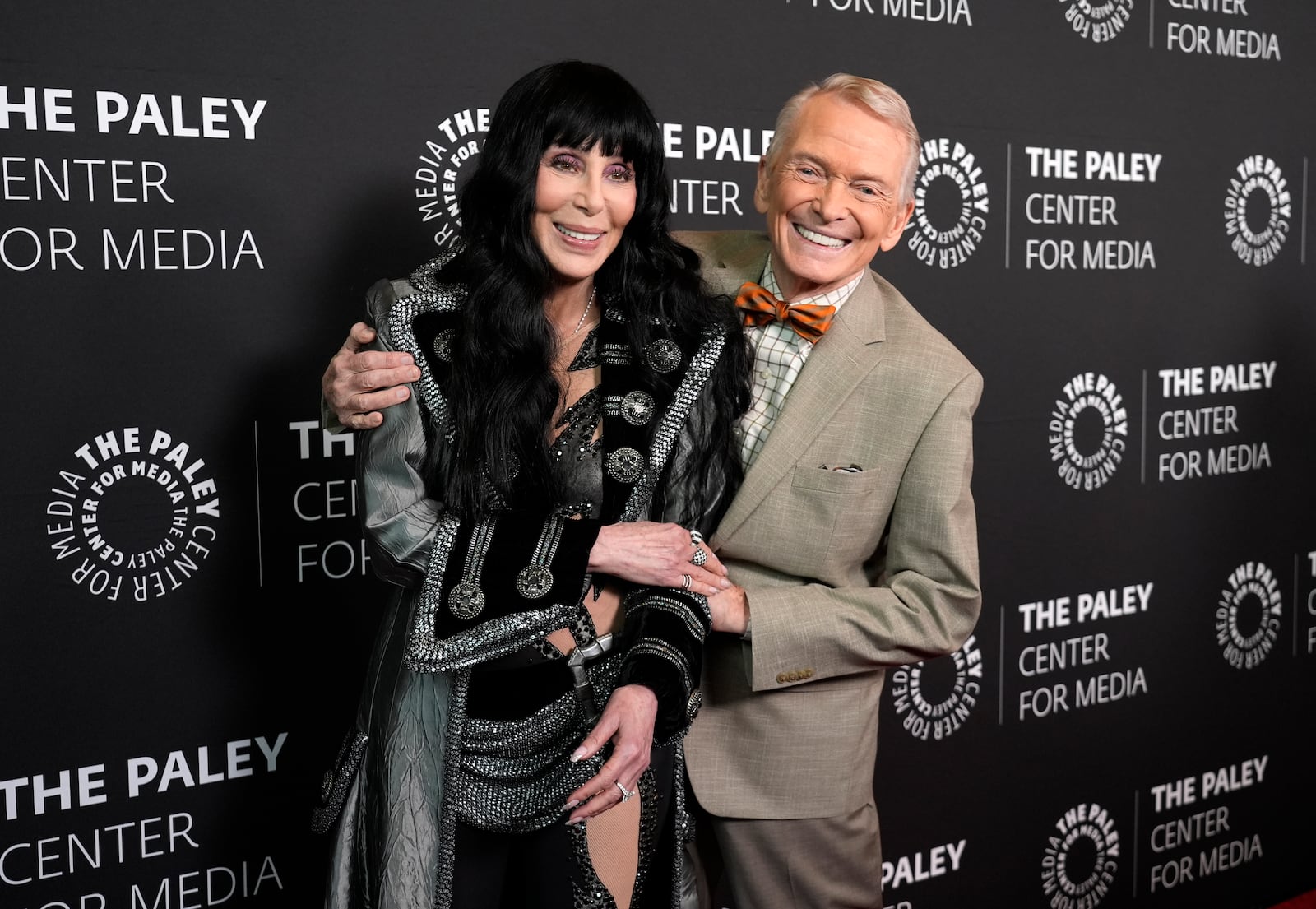 Fashion designer Bob Mackie, right, subject of the documentary film "Bob Mackie: Naked Illusion," poses with Cher at the premiere of the film at the Directors Guild of America, Monday, May 13, 2024, in Los Angeles. The film will be shown Oct. 12 at the Out Here Dayton Film Fest at The Neon. (AP Photo/Chris Pizzello)