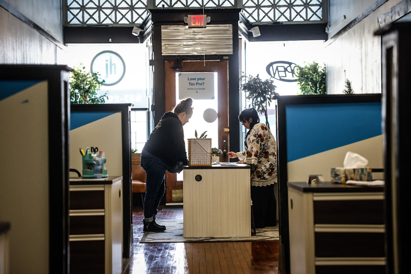 Jackson Hewitt Tax professional, Melissa Kolowena, right, helps a customer at the office on East Third Street in Dayton April 3, 2023. JIM NOELKER/STAFF