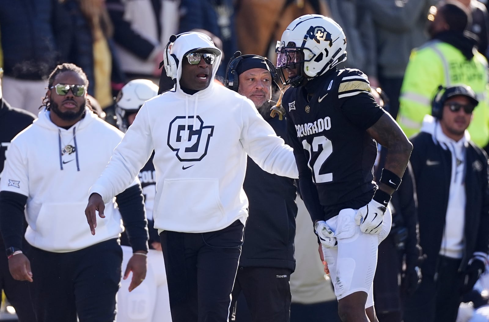 Colorado head coach Deion Sanders, left, confers with wide receiver Travis Hunter in the first half of an NCAA college football game against Oklahoma State Friday, Nov. 29, 2024, in Boulder, Colo. (AP Photo/David Zalubowski)