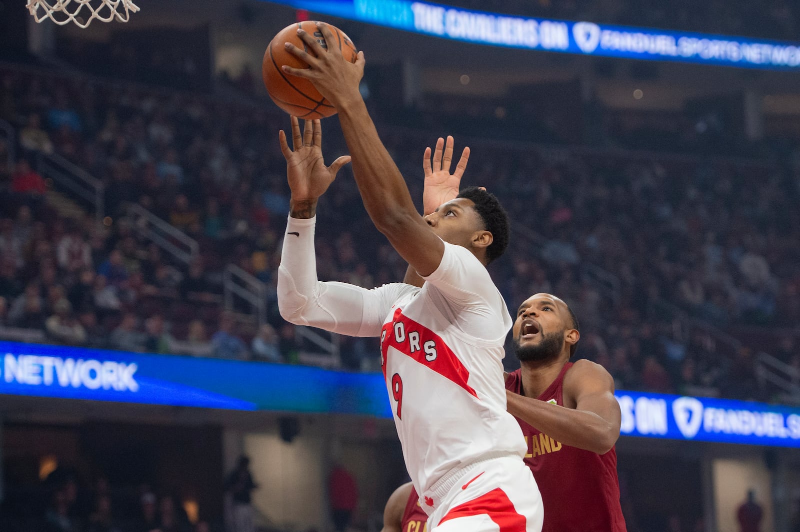 Toronto Raptors' RJ Barrett (9) drives to the basket as Cleveland Cavaliers' Evan Mobley, right, defends during the first half of an NBA basketball game in Cleveland, Thursday, Jan. 9, 2025. (AP Photo/Phil Long)