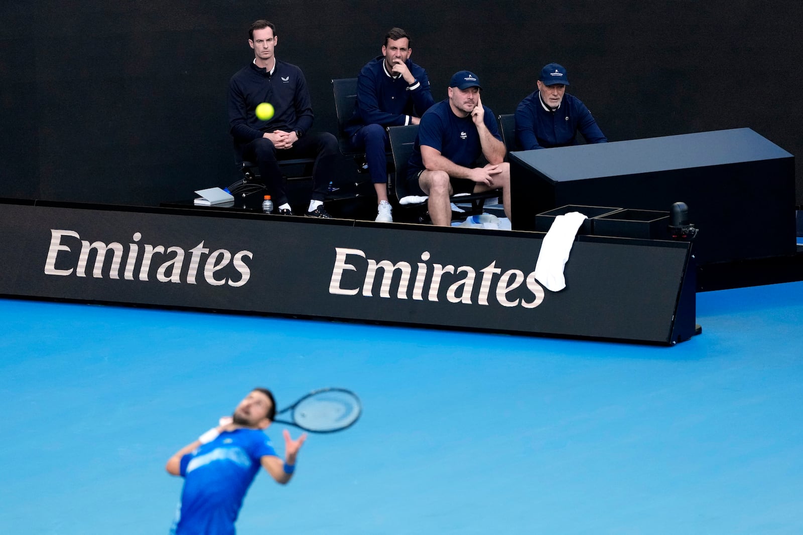 Andy Murray, top left, coach of Novak Djokovic of Serbia watches his first round match against Nishesh Basavareddy of the U.S. at the Australian Open tennis championship in Melbourne, Australia, Monday, Jan. 13, 2025. (AP Photo/Asanka Brendon Ratnayake)