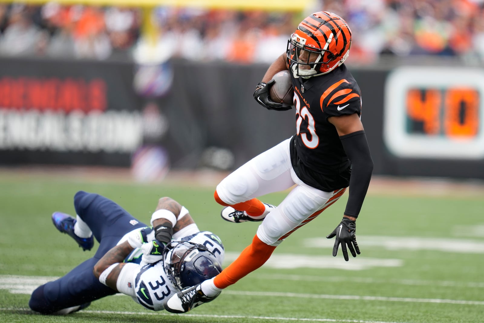 Cincinnati Bengals' Tyler Boyd (83) is tackled by Seattle Seahawks' Jamal Adams during the first half of an NFL football game, Sunday, Oct. 15, 2023, in Cincinnati. (AP Photo/Michael Conroy)