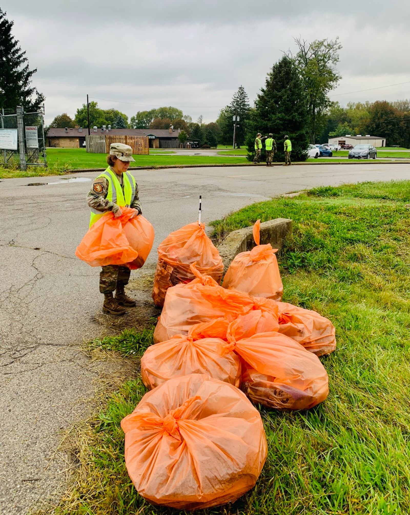 Senior Master Sgt. Shelly Gent of the National Air and Space Intelligence Center organizes multiple trash bags that were used to clean up a portion of state Route 444. A group of NASIC volunteers coordinated with the Ohio Department of Transportation on an Adopt–A-Highway outing to assist the local community. CONTRIBUTED PHOTO