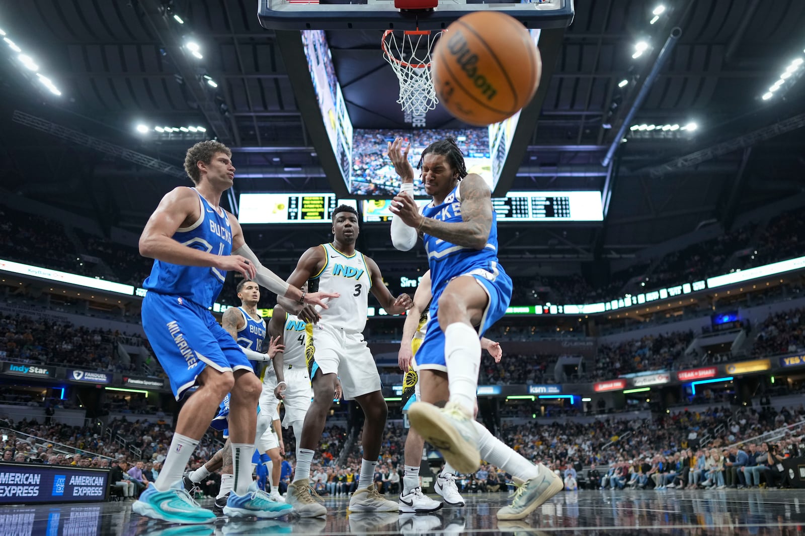 Milwaukee Bucks guard Kevin Porter Jr., right, reacts after being fouled while shooting against the Indiana Pacers during the second half of an NBA basketball game in Indianapolis, Tuesday, March 11, 2025. (AP Photo/AJ Mast)