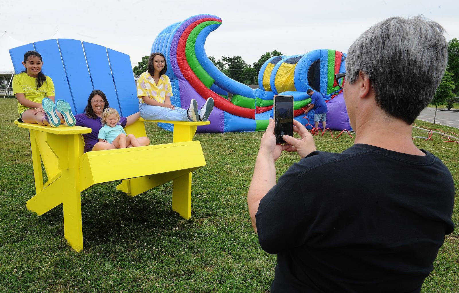 Cathy Ramirez, right, takes a photo Friday June 10, 2022 of, from left, Cecilia Ramirez, 9, Beth Conner, Charlie Stammer, 3, and Katie Conner, 13, at the city of West Carrollton's Sandmazing event located at 1 South Elm Street. MARSHALL GORBY\STAFF