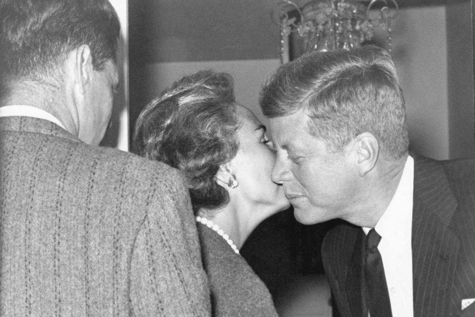 FILE - Mrs. Ethel Kennedy gives a kiss to her brother-in-law, President-elect John Kennedy, at his Georgetown home, Nov. 27, 1960, in Washington. (AP Photo/Henry Griffin, File)