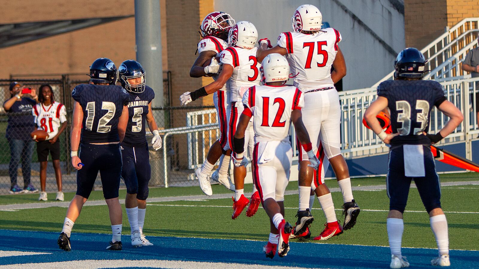 Trotwood-Madison's Dexter Owensby (left) celebrates a 2-yard touchdown with teammates against Fairmont on Friday night. Jeff Gilbert/CONTRIBUTED