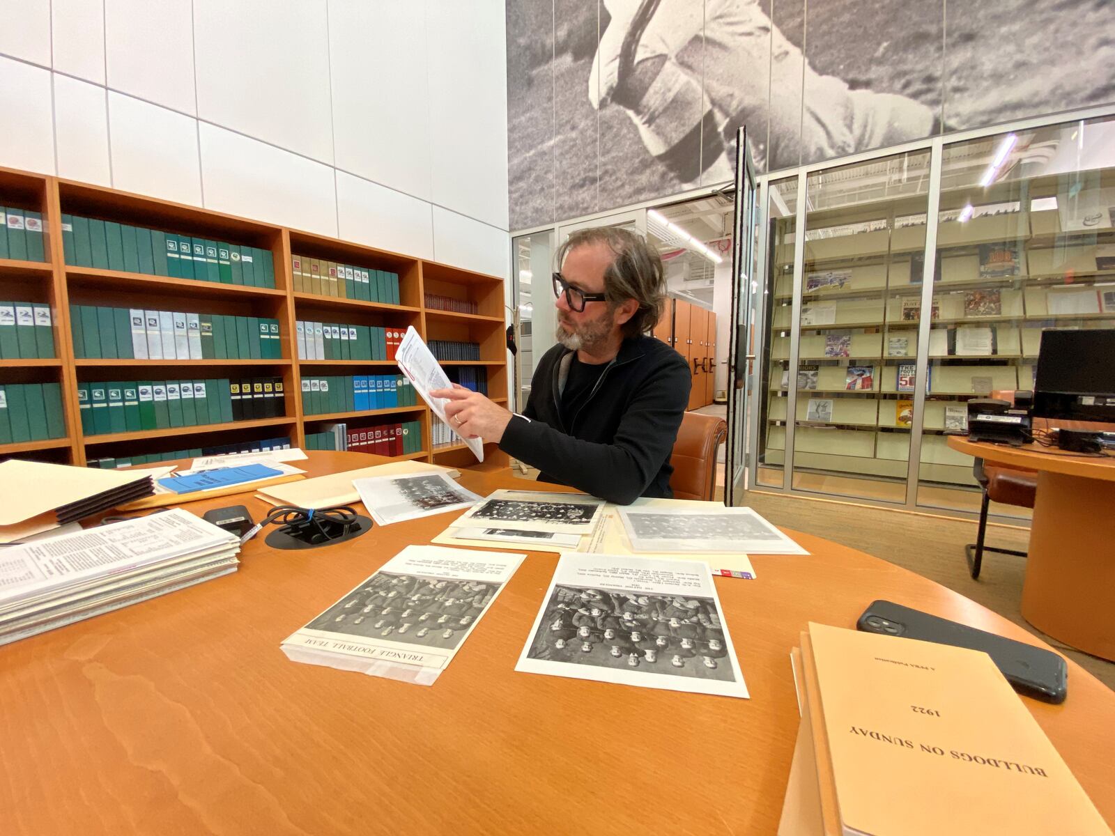 Dayton filmmaker Allen Fast digging into the past at the Pro Football Hall of Fame's archives in Canton. Contributed