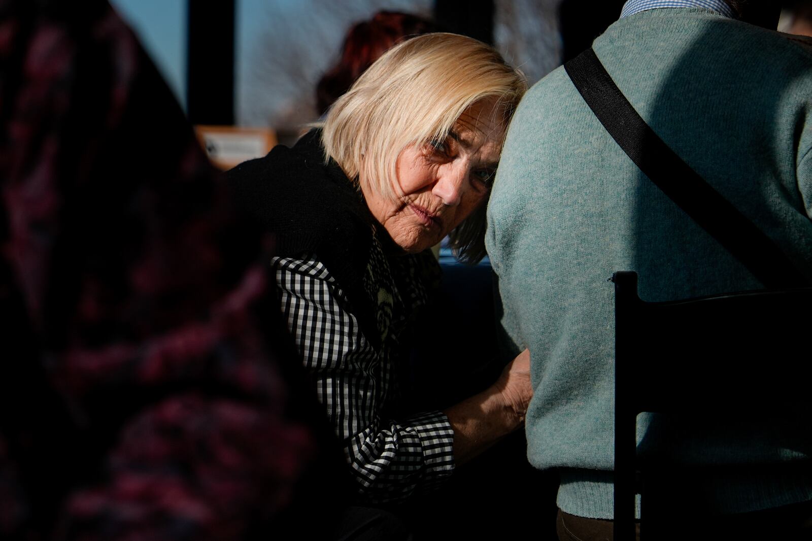 Lyubov Kozhinskaya rests her head on husband Yakov Shvartsevan, a Holocaust survivor, during an International Holocaust Remembrance Day event at the Museum of Jewish Heritage, Monday, Jan. 27, 2025, in New York. (AP Photo/Julia Demaree Nikhinson)