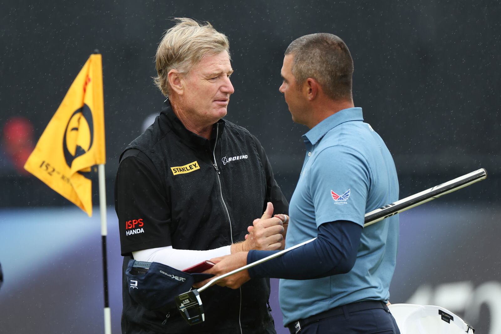 FILE - Ernie Els, left, of South Africa and Gary Woodland of the United States shake hands on the 18th green following their opening round of the British Open Golf Championships at Royal Troon golf club in Troon, Scotland, Thursday, July 18, 2024. (AP Photo/Scott Heppell, File)