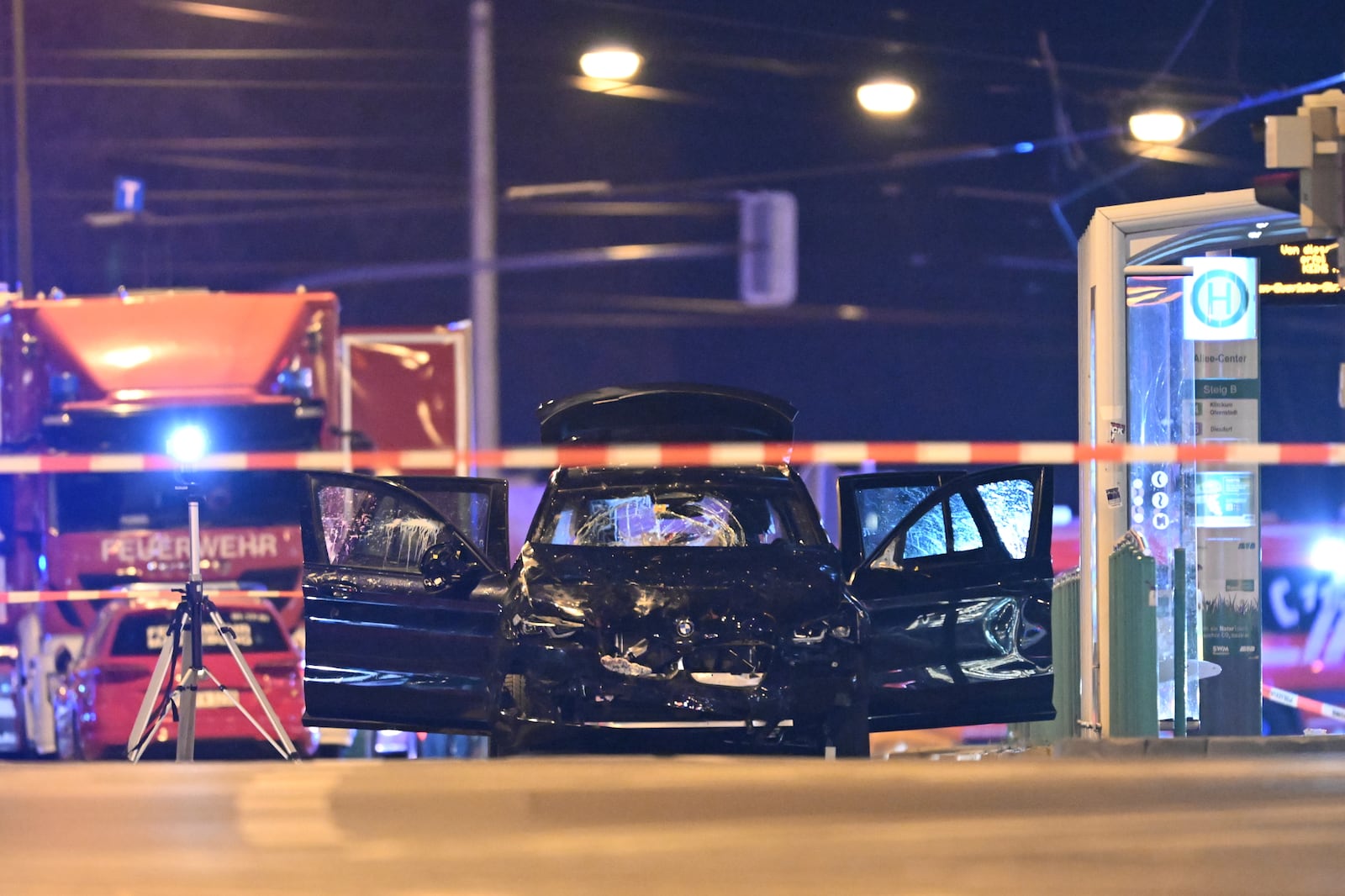 A damaged car sits with its doors open after a driver plowed into a busy Christmas market in Magdeburg, Germany, early Saturday, Dec. 21, 2024. (Hendrik Schmidt/dpa via AP)