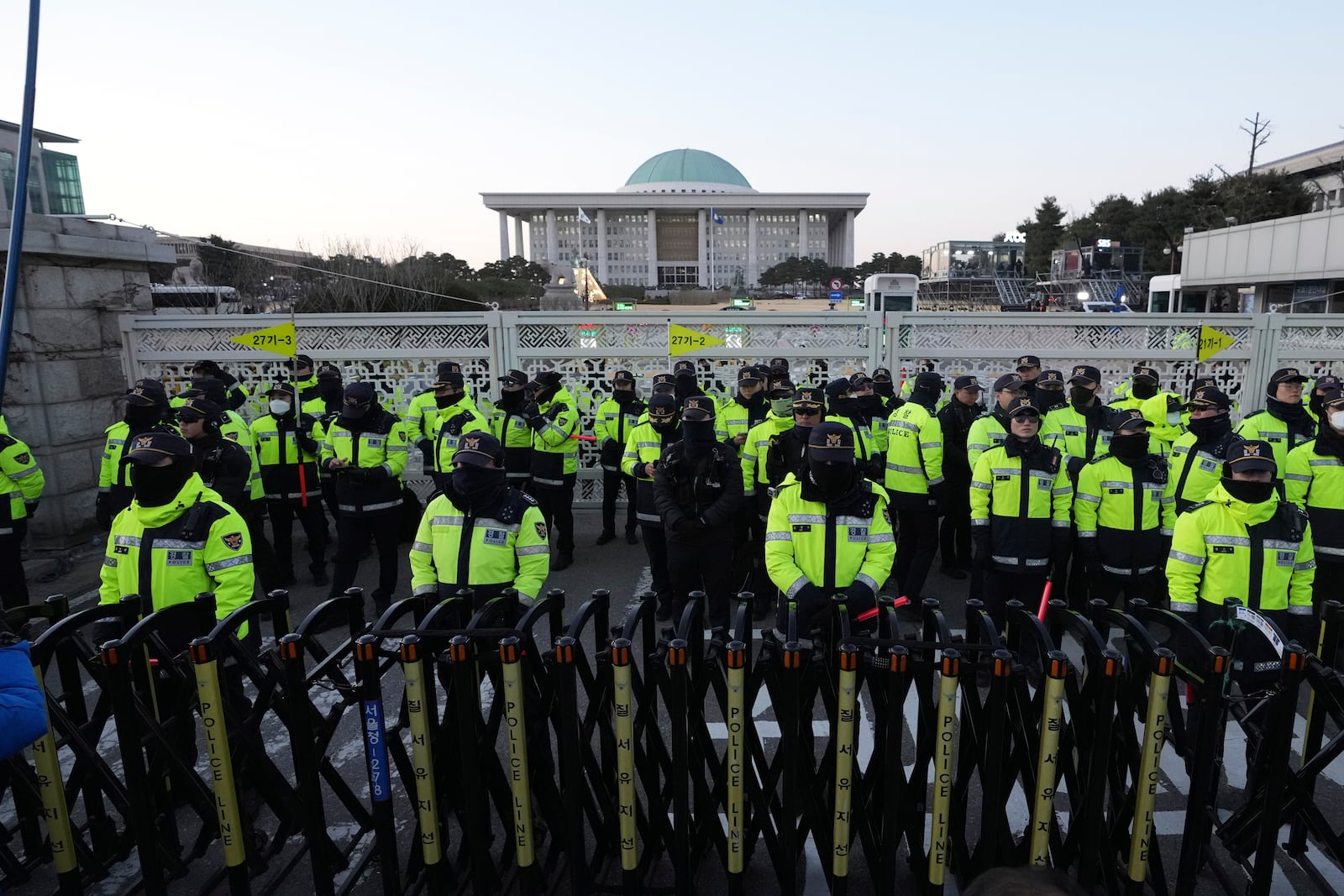 Police officers stand guard in front of the National Assembly in Seoul, South Korea, Saturday, Dec. 14, 2024. (AP Photo/Lee Jin-man)