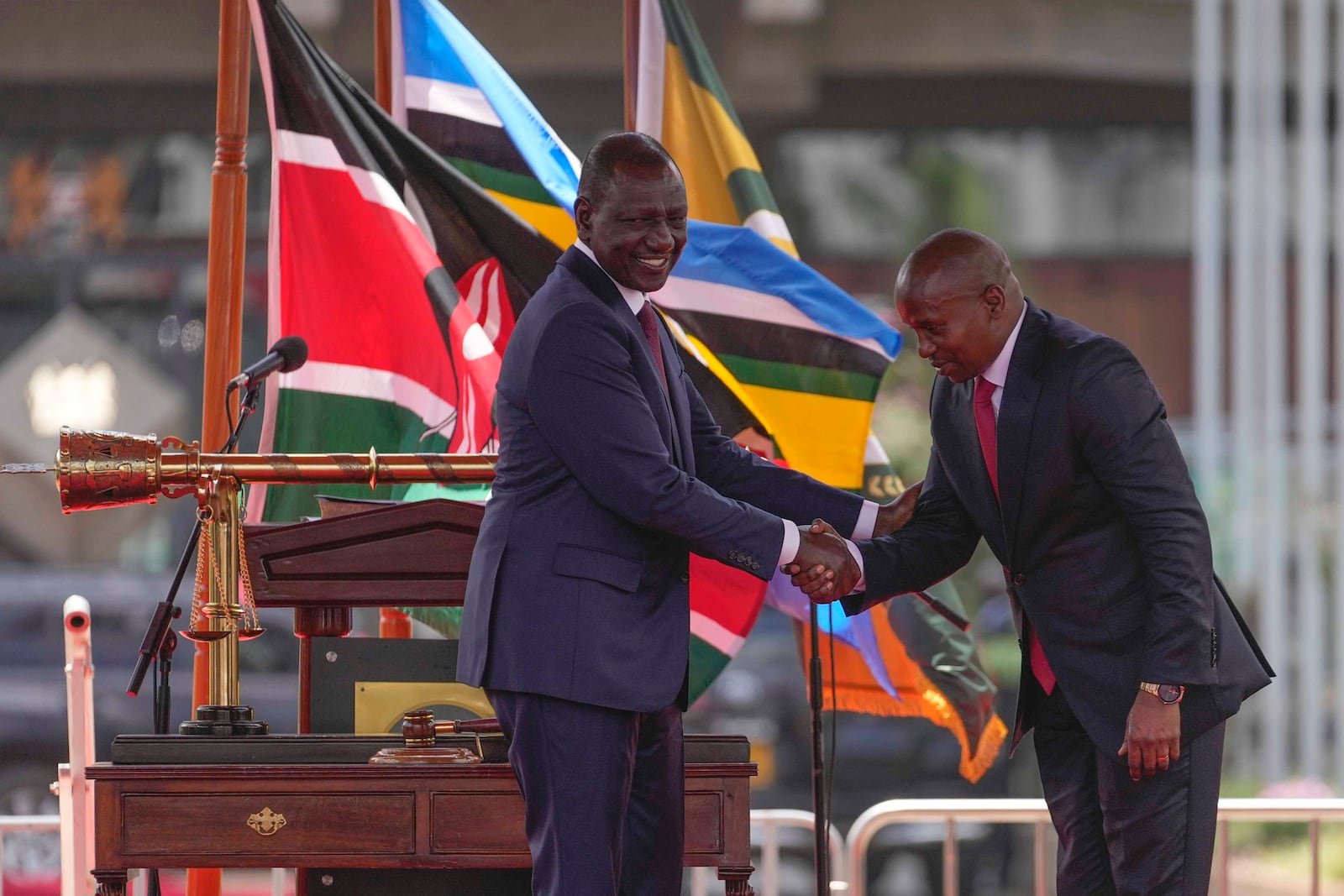 Kenya's new Deputy President Kithure Kindiki, right, shakes hands with Kenya's President William Ruto, during his swearing in ceremony, at Kenyatta International Convention Centre, in Nairobi, Kenya Friday, Nov. 1, 2024. (AP Photo/Brian Inganga)