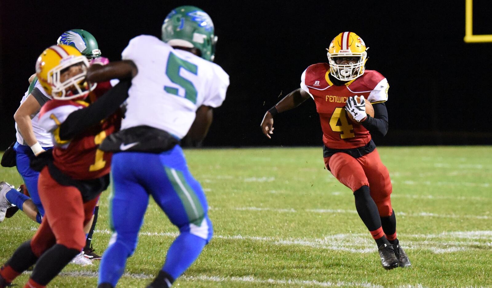 Fenwick’s Caleb Davis (4) looks toward the edge as Chaminade Julienne’s Marquis George (5) tries to make a play Friday night at Krusling Field in Middletown. Fenwick won the Division III, Region 12 playoff game 28-7. CONTRIBUTED PHOTO BY ANGIE MOHRHAUS