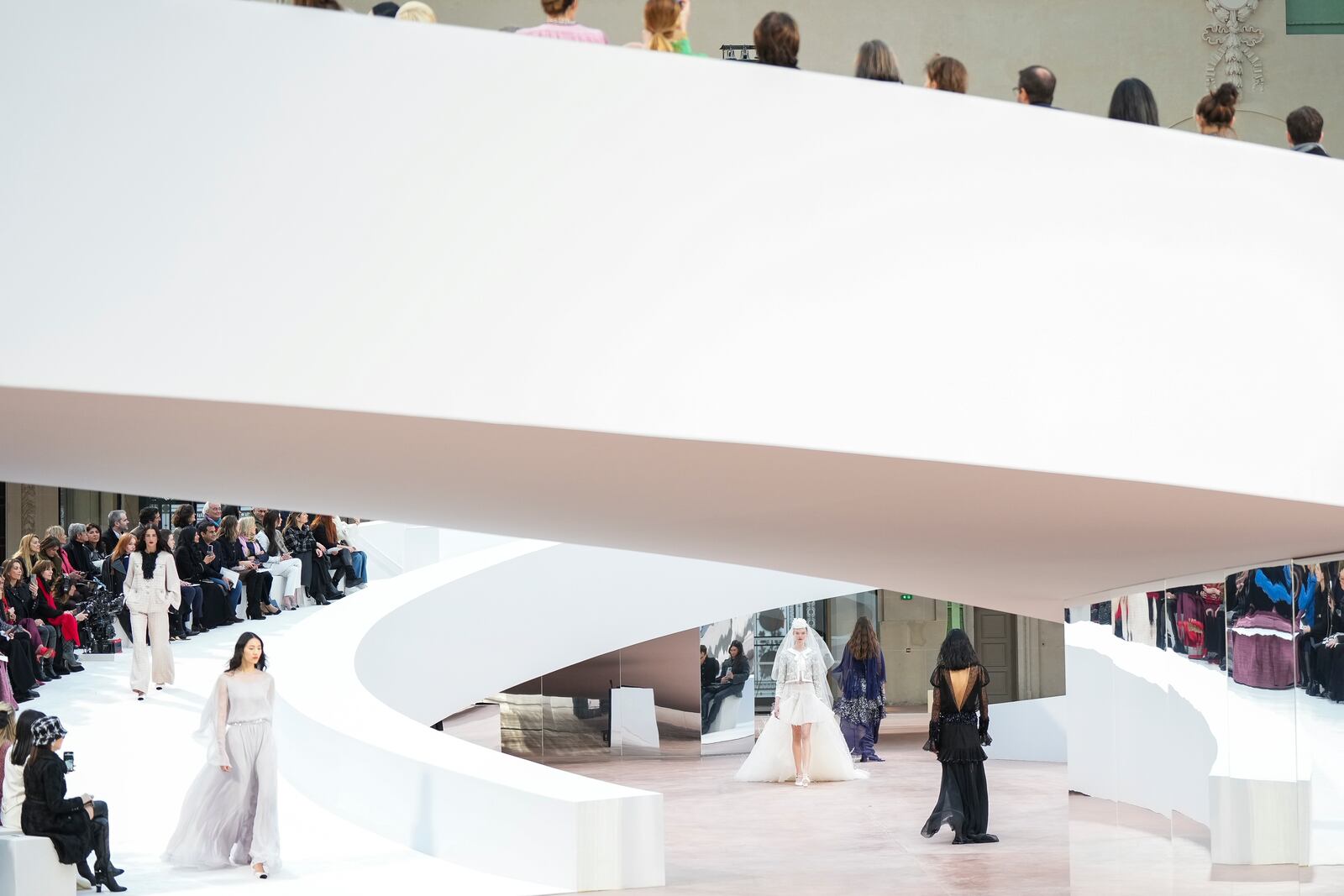 Models wear creations as part of the Chanel Haute Couture Spring Summer 2025 collection, that was presented in Paris, Tuesday, Jan. 28, 2025. (AP Photo/Lewis Joly).