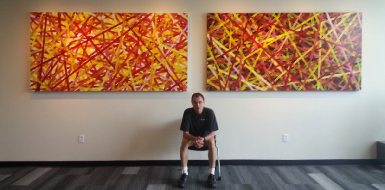 In addition to the Sculptures on the Square, local artists were invited to submit art for display at Troy businesses and shops.  Pictured, artist Darren Kall with one of his line pattern series. CONTRIBUTED