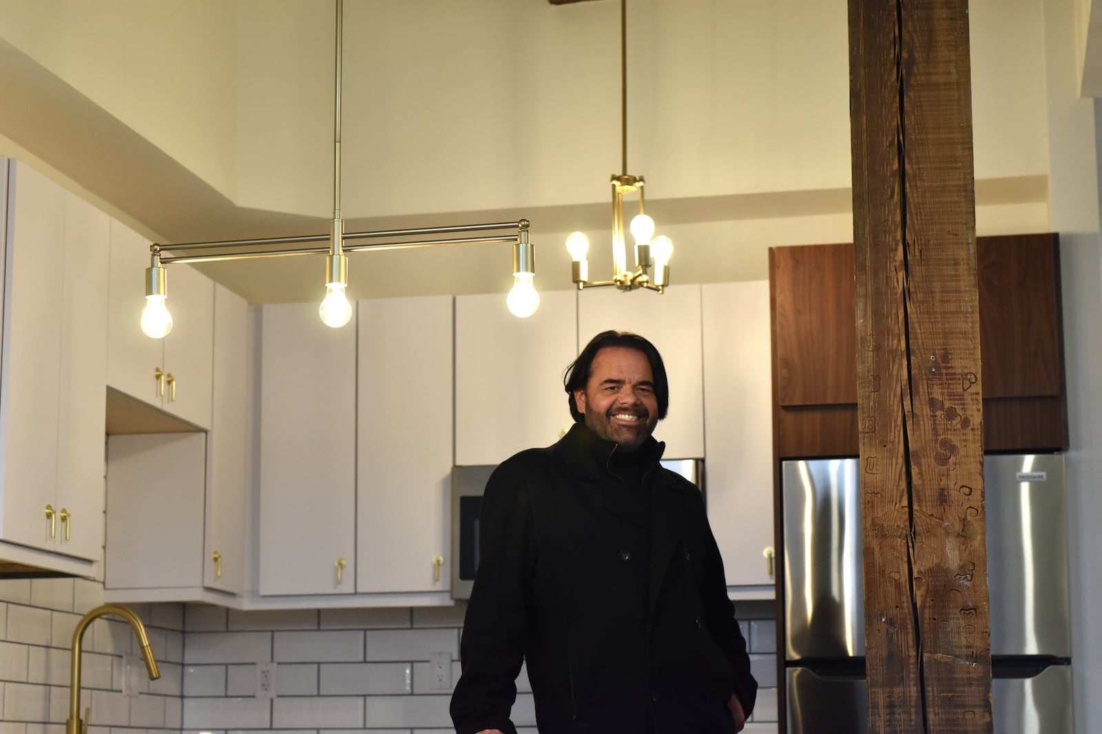 Jason Dorsey, asset director for Windsor Companies, inside one of the 19 new apartments in the Home Telephone building on South Jefferson Street in downtown Dayton. Windsor Companies has transformed the building, which was most recently Price Stores, a men's clothing business. Dorsey does the designs for the company's residential units. Preleasing for the lofts begin on Saturday, Dec. 9, 2023. CORNELIUS FROLIK / STAFF