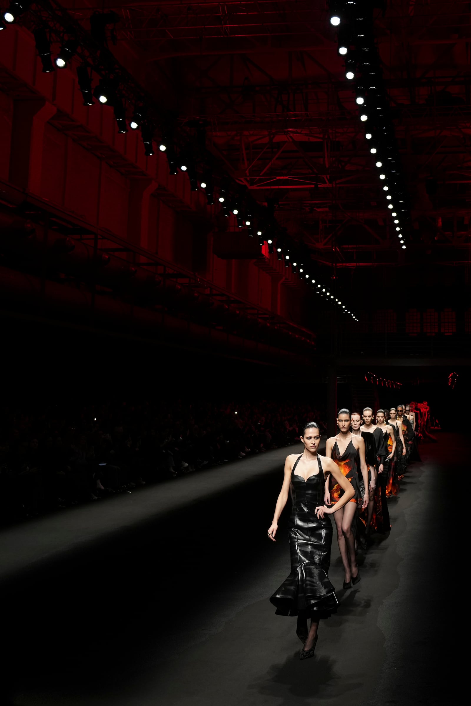 Models wear creations as part of the Roberto Cavalli Fall/Winter 2025-2026 Womenswear collection presented in Milan, Italy, Thursday, Feb. 27, 2025. (AP Photo/Antonio Calanni)