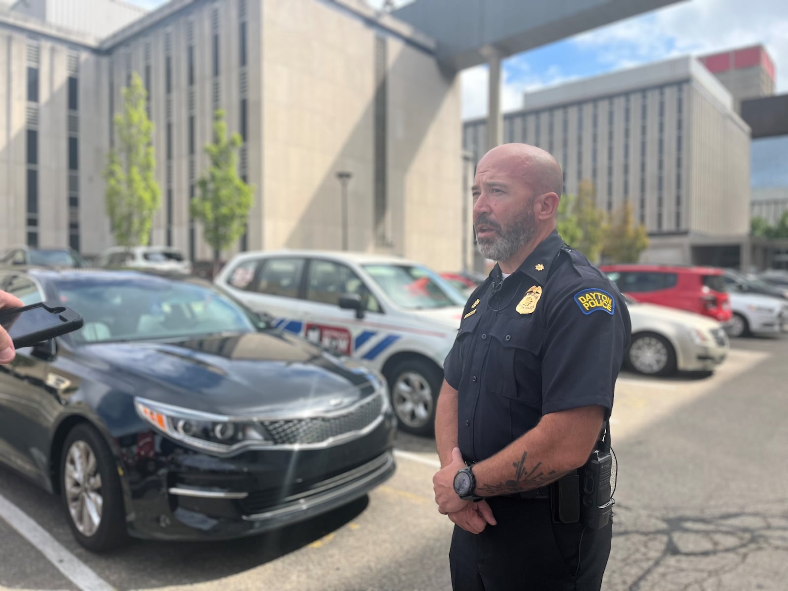 Dayton police Major Jason Hall, commander of the Patrol Operations Division, talks about Kia and Hyundai thefts in Dayton. In the background, in the public safety building parking lot, is a parked Kia. CORNELIUS FROLIK / STAFF