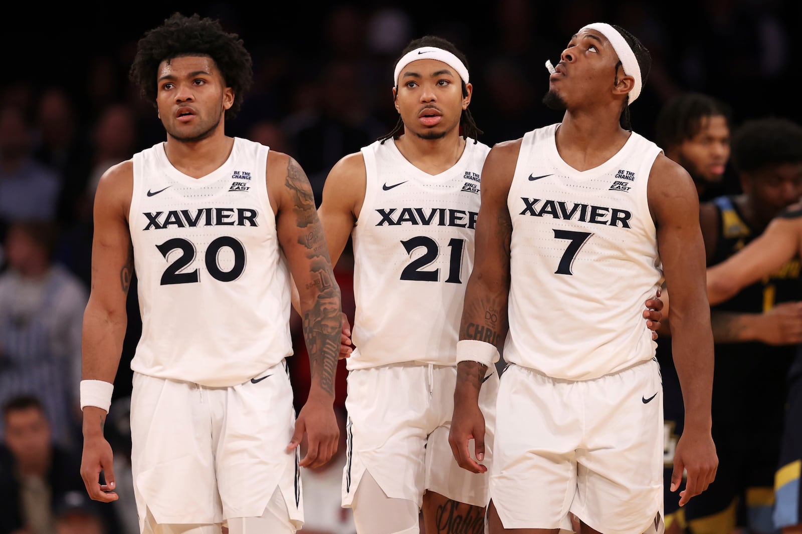 Xavier's Dayvlon McKnight (20), Dante Maddox Jr. (21) and Ryan Conwell (7) stand on the court during the second half of an NCAA college basketball game against Marquette in the quarterfinals of the Big East Conference tournament, Thursday, March 13, 2025, in New York. (AP Photo/Pamela Smith)