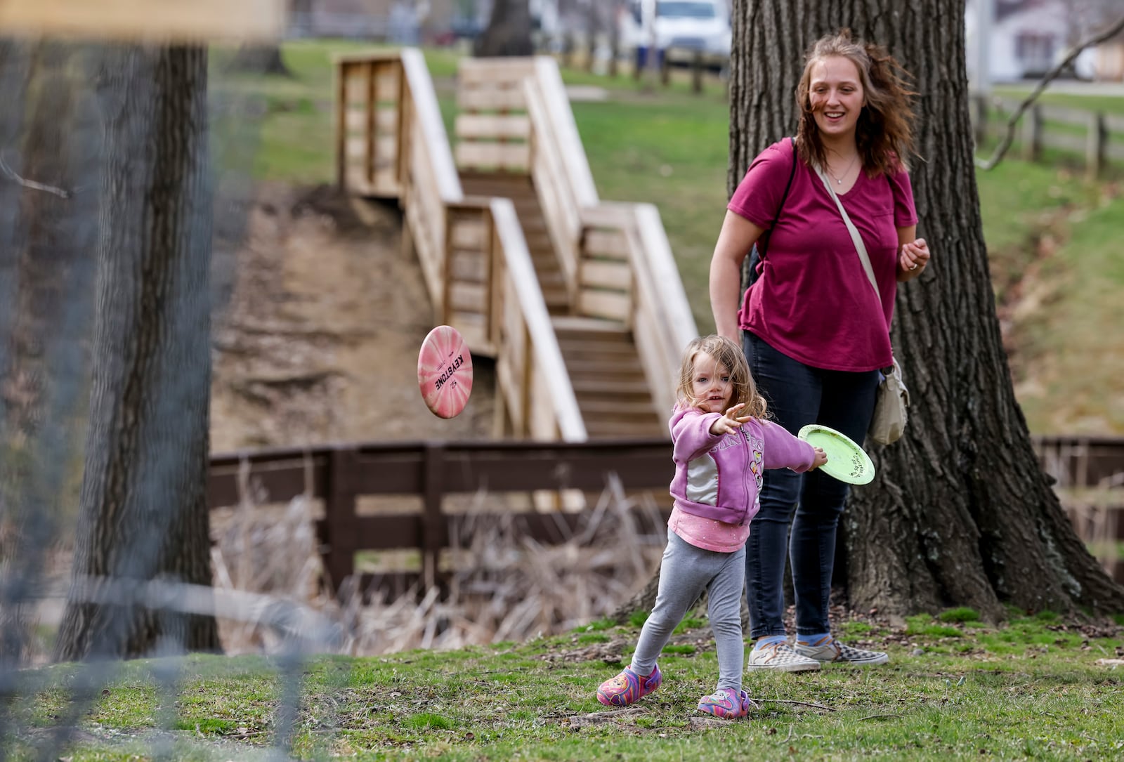 Miah Dawson and her daughter Luna, 2, take advantage of the nice weather to play disc golf Wednesday, March 30, 2022. NICK GRAHAM/STAFF