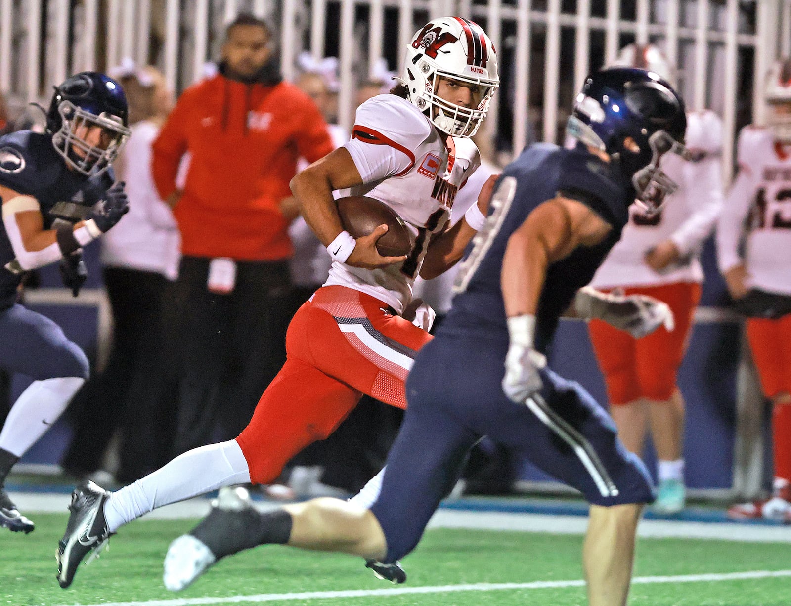 Wayne's Tyrell Lewis races Fairmont's Toby Deglow to the end zone for a Warriors' touchdown during round two of the playoffs Friday, Nov. 8, 2024. BILL LACKEY/STAFF