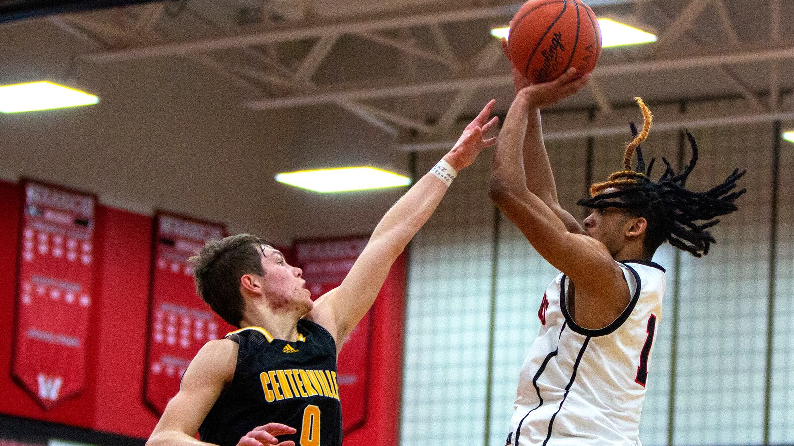 Wayne's Lawrent Rice shoots over Centerville's Gabe Cupps during Friday night's game at Wayne. Rice scored 22 points in the Warriors' 48-43 win. Cupps led the Elks with 20. CONTRIBUTED/Jeff Gilbert