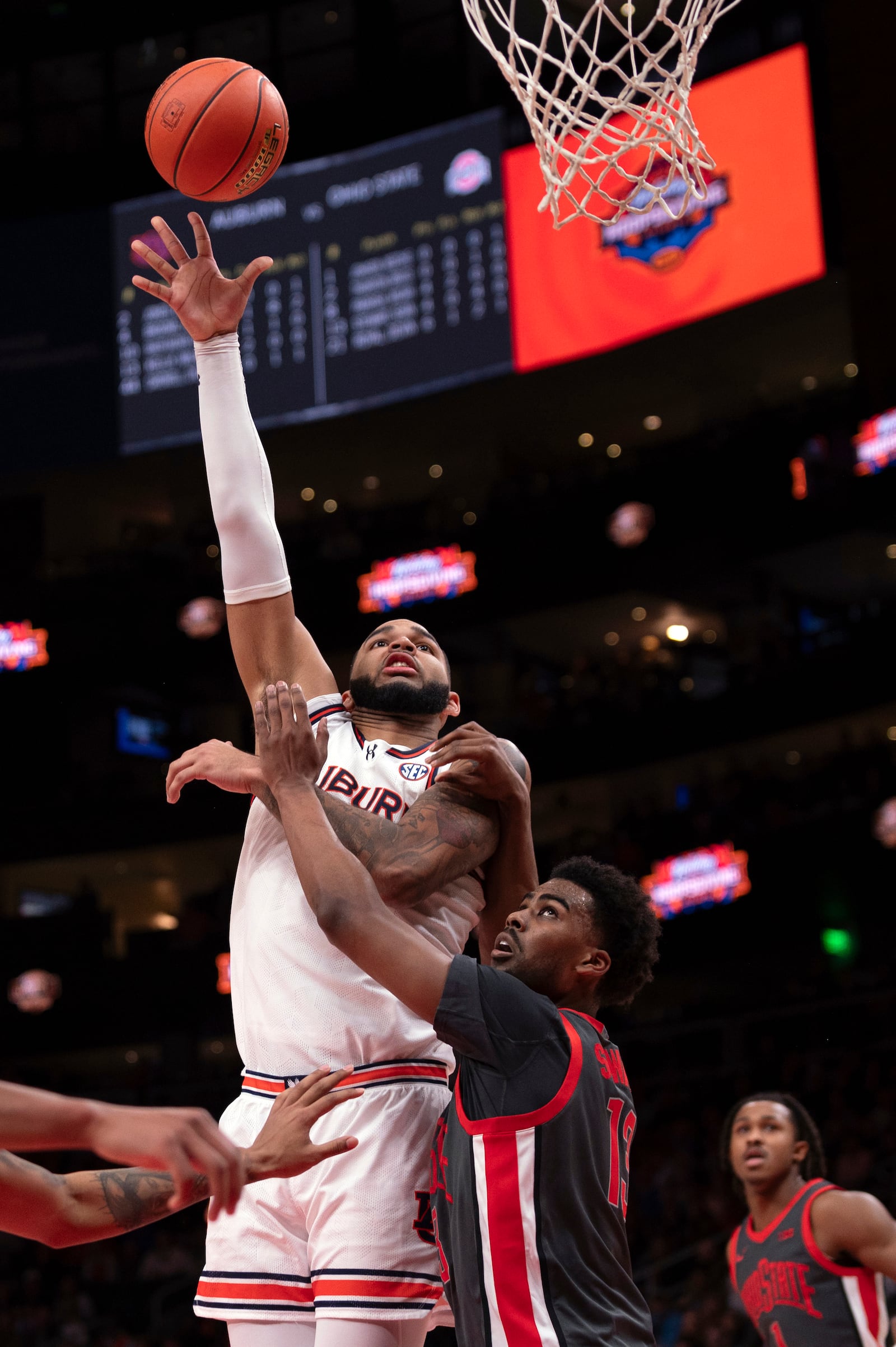 Auburn forward Johni Broome (4) shoots over Ohio State forward Sean Stewart (13) during the first half of an NCAA college basketball game against Ohio State on Saturday, Dec. 14, 2024, in Atlanta. (AP Photo/Kathryn Skeean)