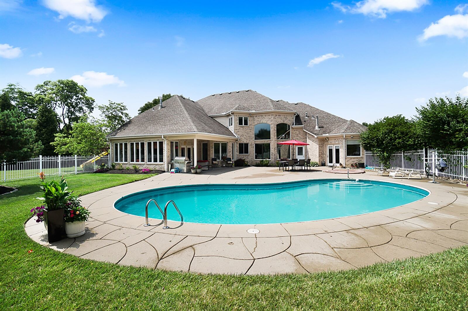 A sun room has a wet bar, access to a full bathroom and leads to the covered outside patio and pool deck. CONTRIBUTED PHOTO