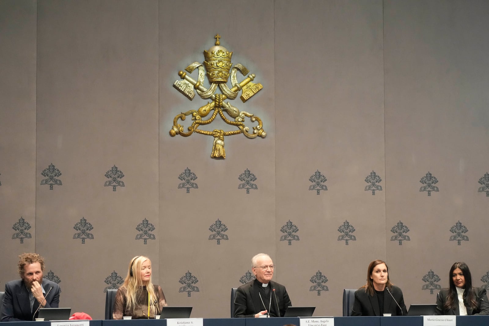 From left, Italian artist Lorenzo Jovanotti Cherubini, Icelandic artist Kristjana S. Williams, Mons. Angelo Vincenzo Zani, Vatican Archivist, Dior Artistic Director Maria Grazia Chiuri and Creative director, Chanakya International Karishma Swali attend a press conference presenting the exhibition "En Route" organized by the Vatican Apostolic Library exploring world tours of the late 19th century at the Vatican, Friday, Jan. 31, 2025. (AP Photo/Gregorio Borgia)