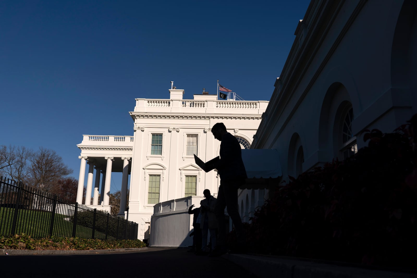 Journalists walk outside of the White House briefing room, in Washington, Tuesday, March 18, 2025.. (AP Photo/Jose Luis Magana)