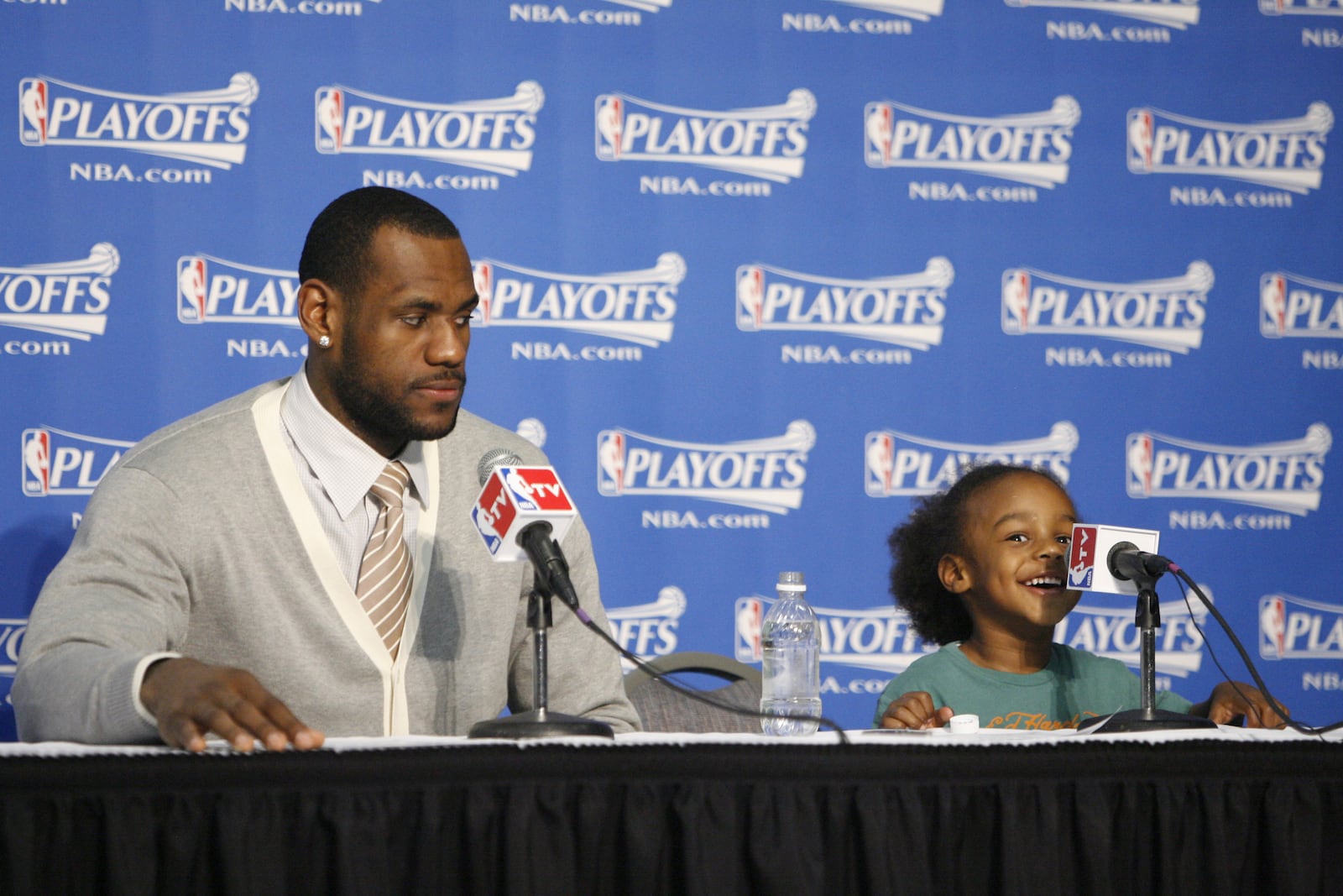 FILE - Cleveland Cavaliers LeBron James and his son LeBron James Jr. during a post game interview Saturday May 10, 2008, after the Cavaliers beat the Boston Celtics 108-84 at Quicken Loans Arena in Cleveland, Ohio. (Bob Rossiter/The Canton Repository via AP, File)