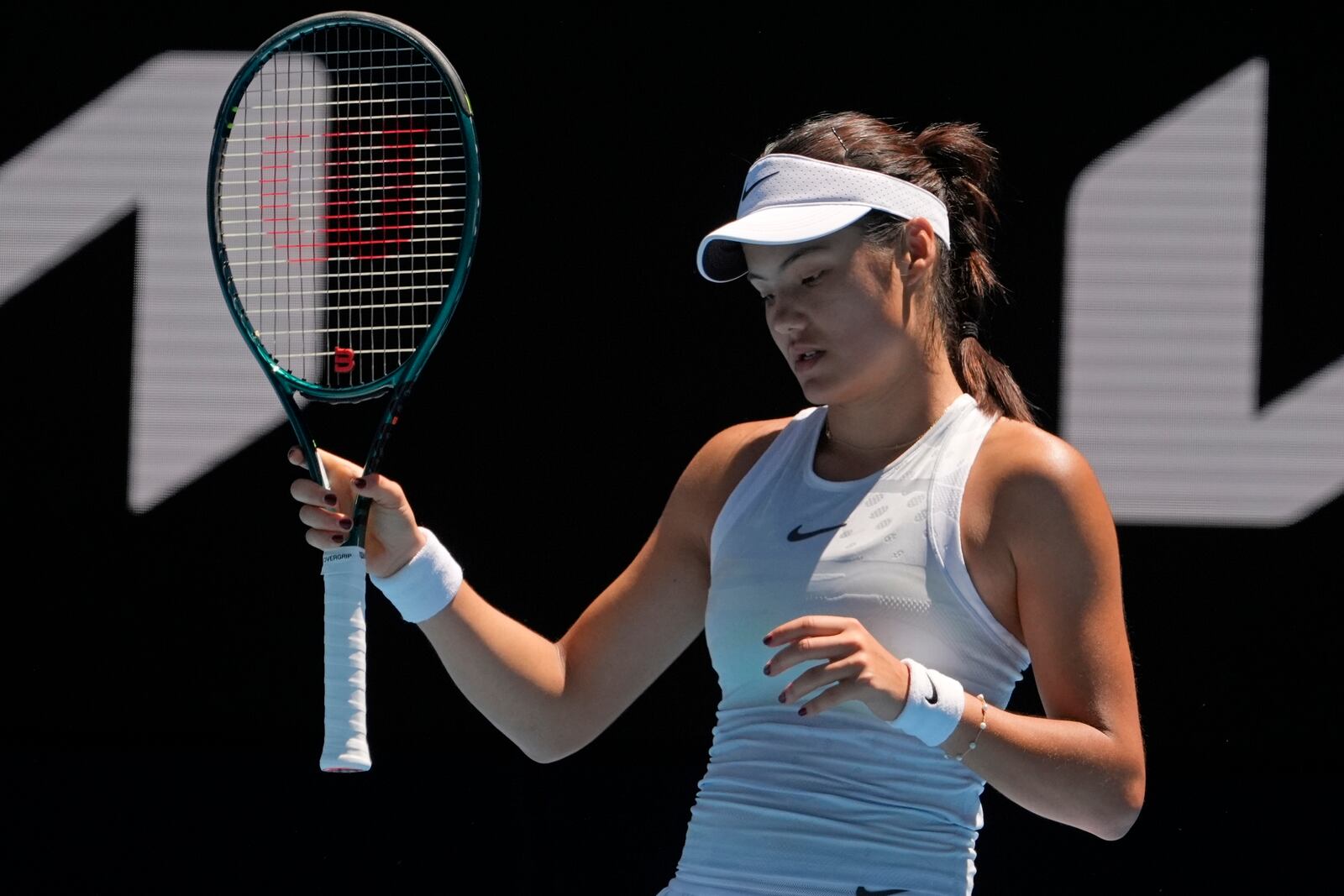 FILE - Emma Raducanu of Britain reacts during her third round match against Iga Swiatek of Poland at the Australian Open tennis championship in Melbourne, Australia, Saturday, Jan. 18, 2025. (AP Photo/Asanka Brendon Ratnayake, File)