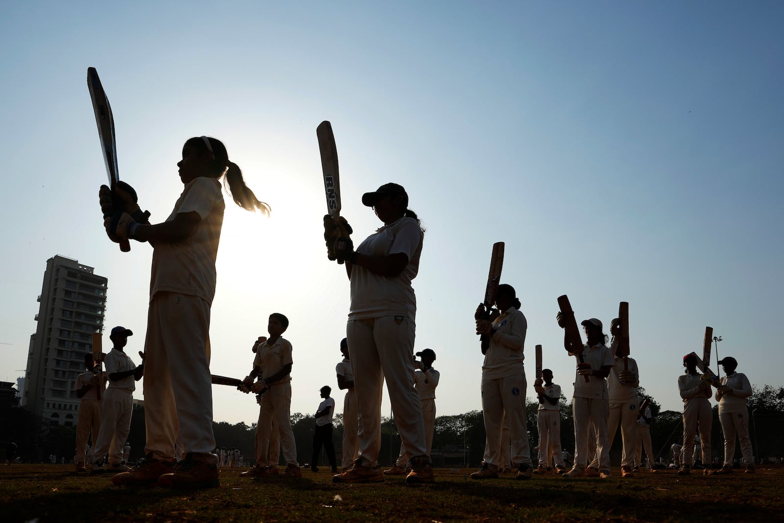 Indian children practice batting at a cricket coaching camp in Mumbai, India, Friday, Feb. 21, 2025. (AP Photo/Rajanish Kakade)