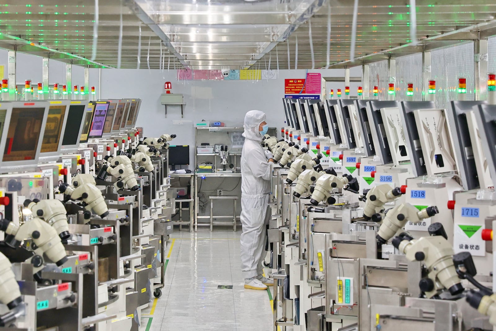 FILE - A man works at a manufacturer of Integrated Chip encapsulation in Nantong in eastern China's Jiangsu province on Friday, Sept. 16, 2022. (Chinatopix Via AP, File)