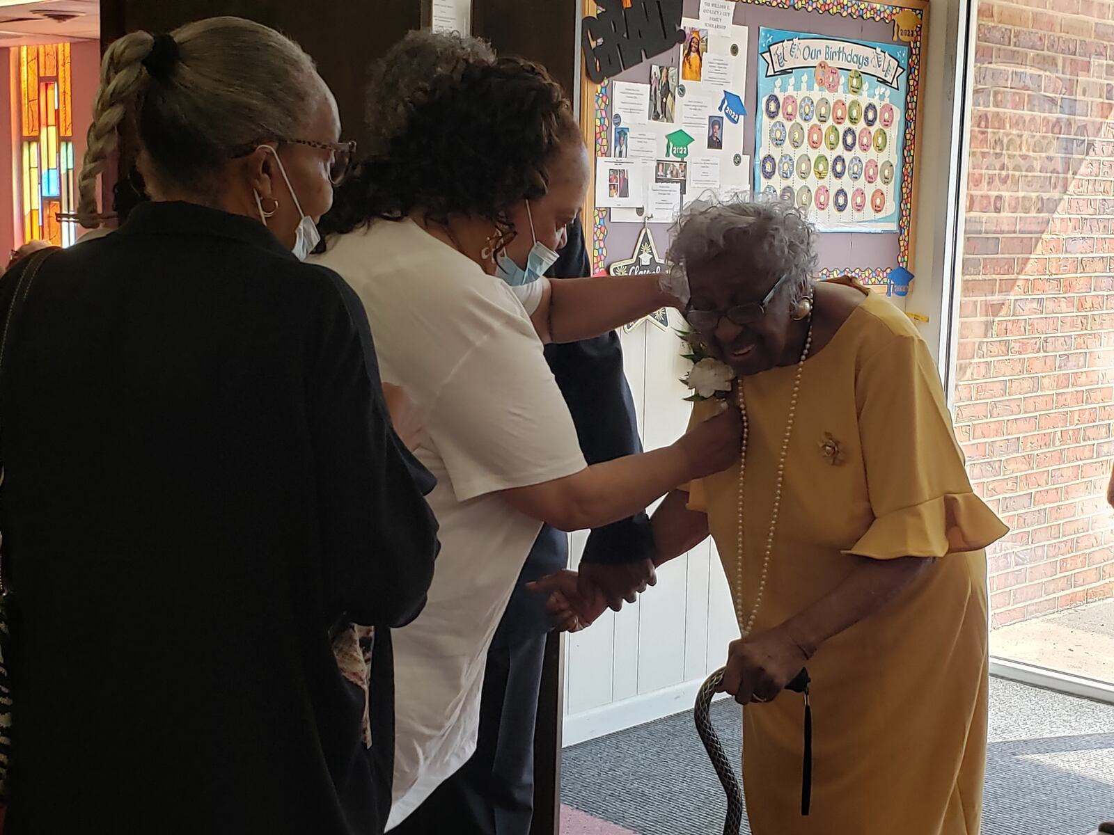 Joann Bankston pins a corsage on Verdell Dawson in honor of her 100th birthday at Summit Christian Church in August 2022. CONTRIBUTED