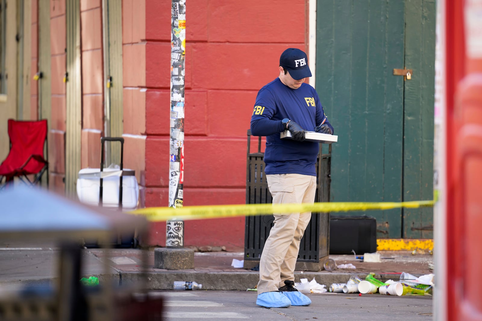 The FBI investigates the area on Orleans St and Bourbon Street by St. Louis Cathedral in the French Quarter where a suspicious package was detonated after a person drove a truck into a crowd earlier on Bourbon Street on Wednesday, Jan. 1, 2025. (AP Photo/Matthew Hinton)