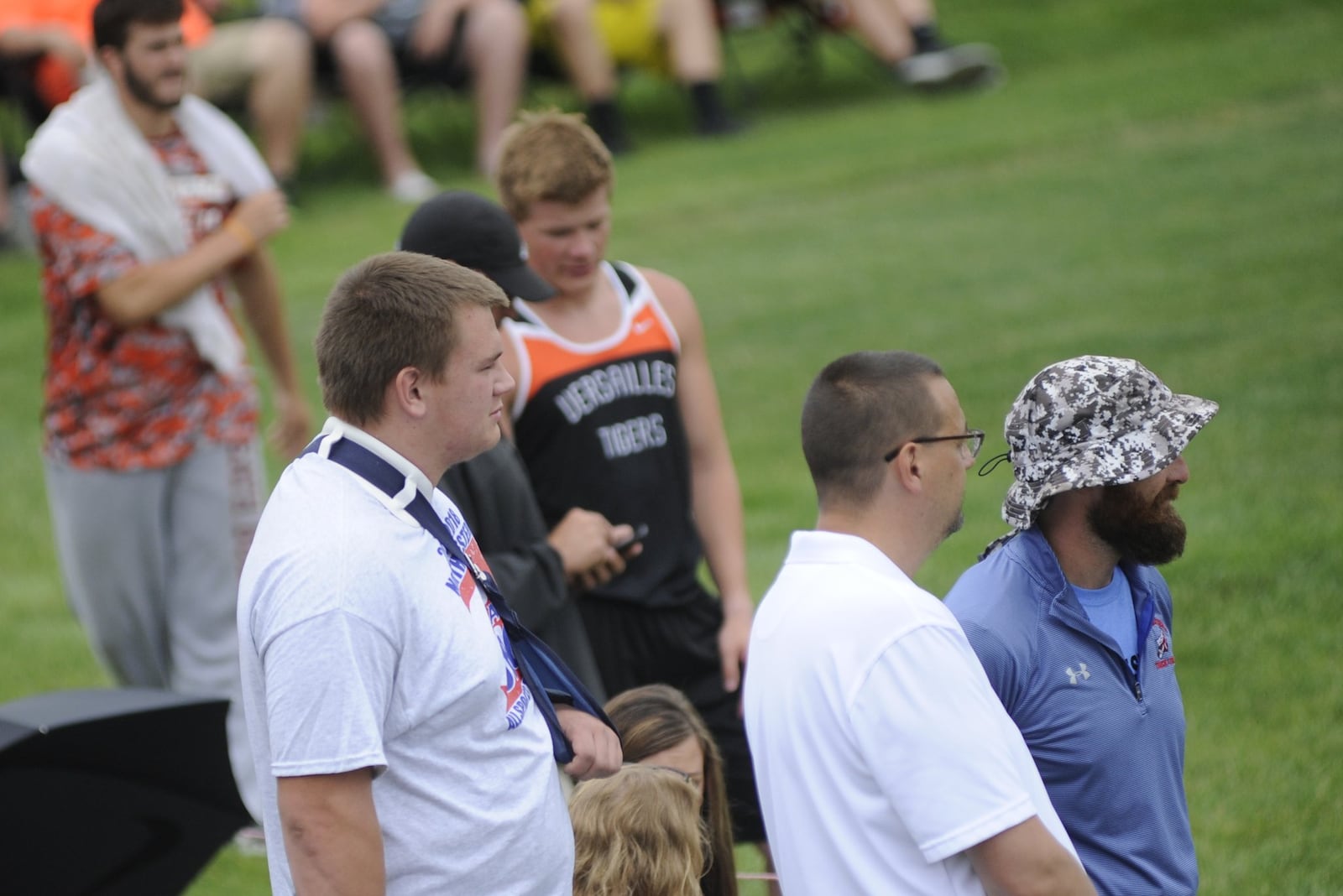 Adam Riedinger (left), his father Mark and Northwestern coach Brian Stevenson watch the shot put competition during the D-II state track and field meet at OSU’s Jesse Owens Memorial Stadium on Friday, June 1, 2018. MARC PENDLETON / STAFF