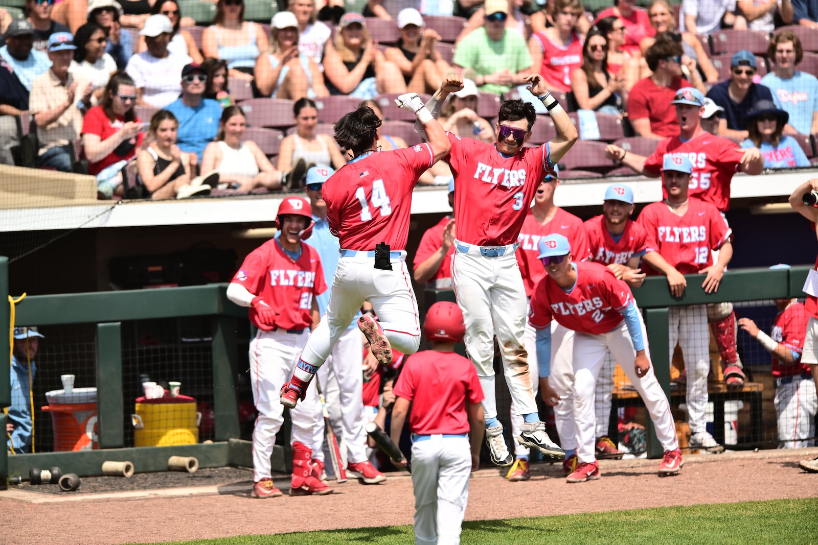 The Dayton baseball team celebrates a run during a game against Davidson at Day Air Ballpark in 2024. Photo by Erik Schelkun